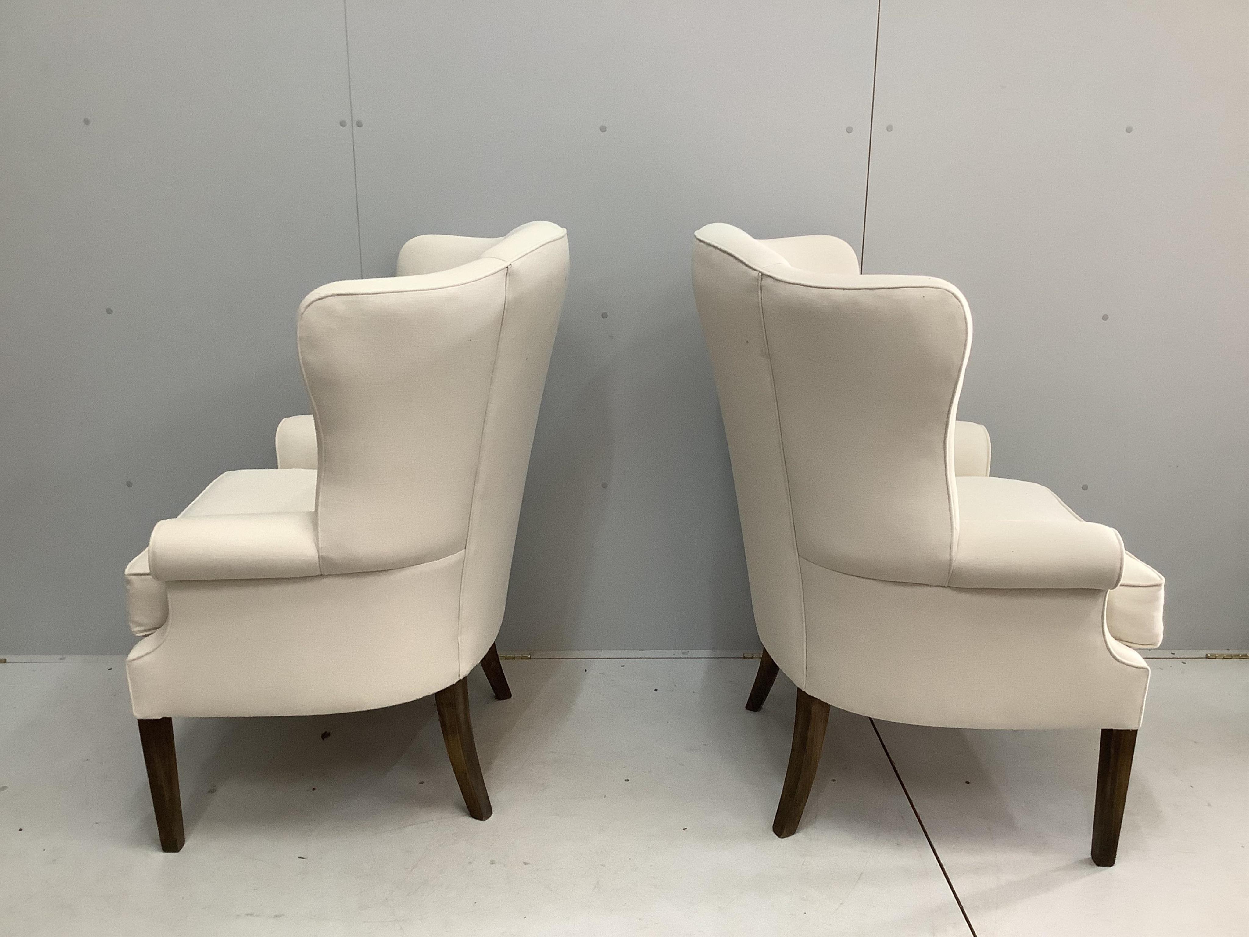 A pair of modern upholstered wingback armchairs, width 86cm, depth 74cm, height 114cm. Condition - good